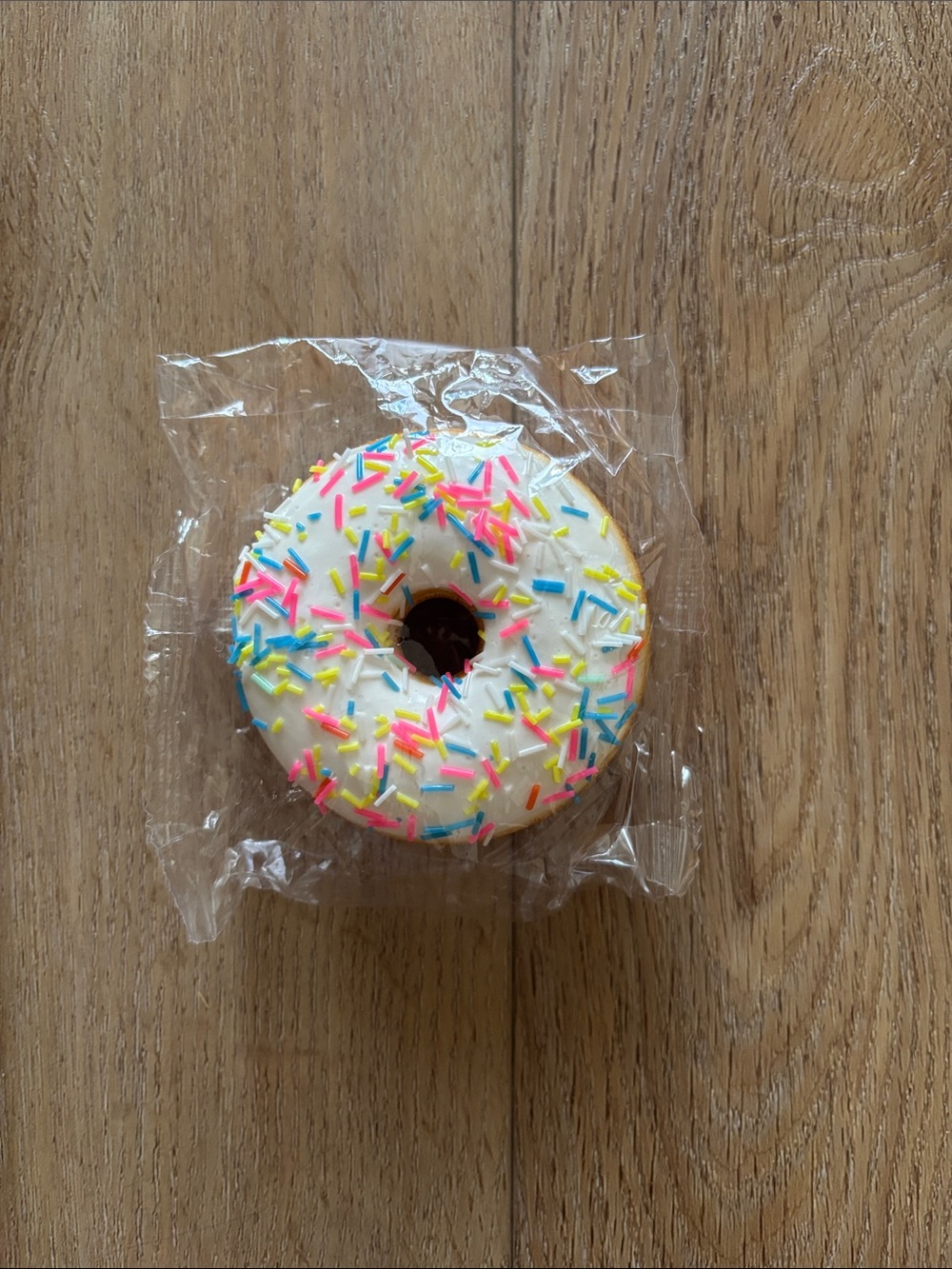 Squishy Donut Toy with White Icing and Colorful Sprinkles